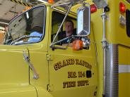 Firemen in a yellow fire truck 